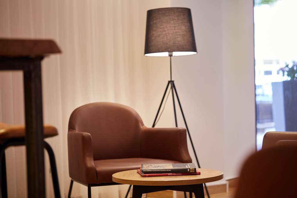 scandic berlin kurfuerstendamm lobby books armchair cozy