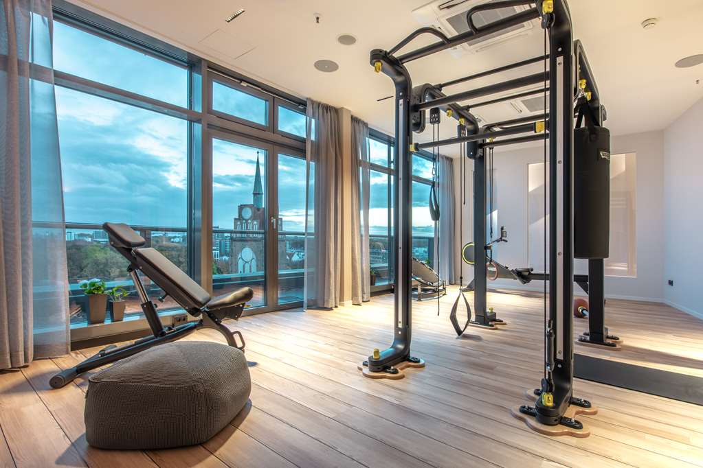 Fitness center with evening city view