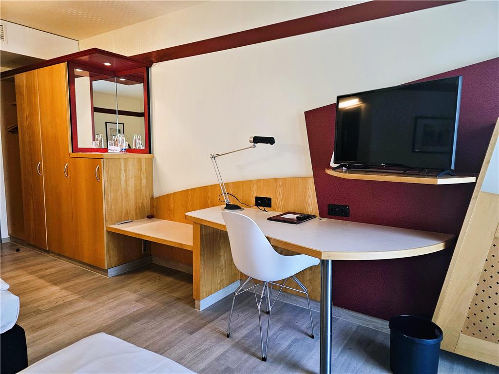 Comfort triple room with double bed and sofa bed, desk, spacious wardrobe, wall mirror, seating, TV, bathroom