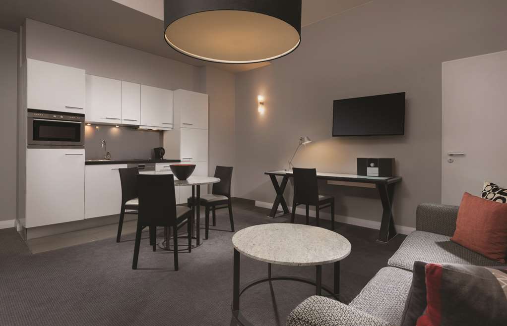 adina apartment hotel berlin checkpoint charlie one bedroom apartment lounge room and kitchen