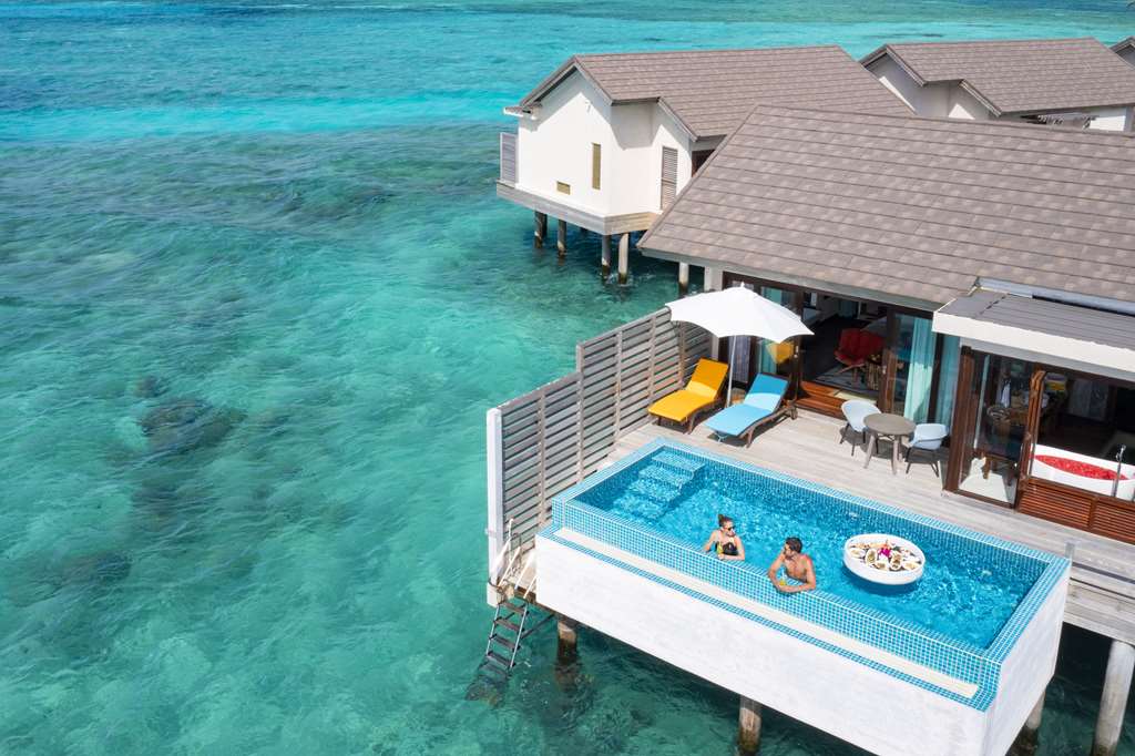 ATMOSPHERE KANIFUSHI MALDIVES SUNSET WATER VILLA WITH POOL AERIAL PRIMARY