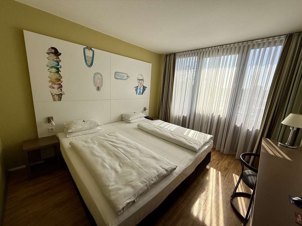 Comfort double room with double bed, desk, spacious wardrobe, wall mirror, seating, TV, bathroom